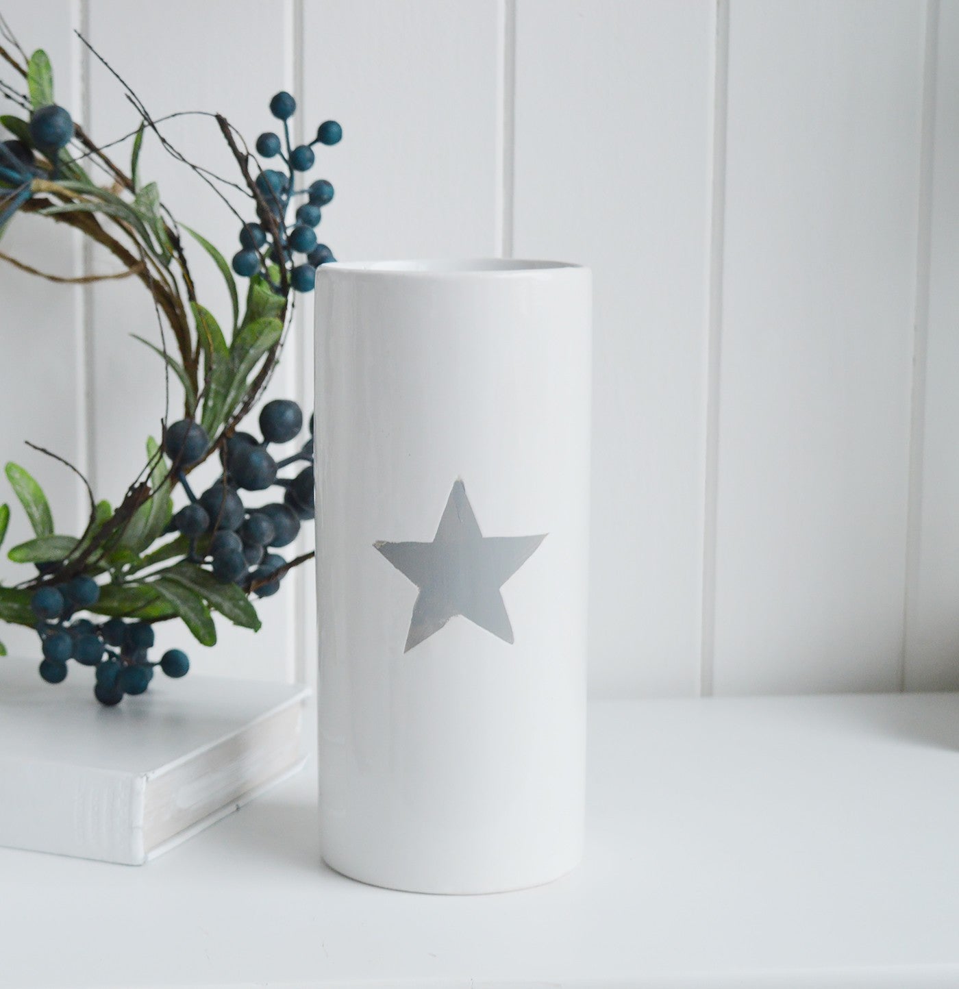 White ceramic vase with grey painted star.